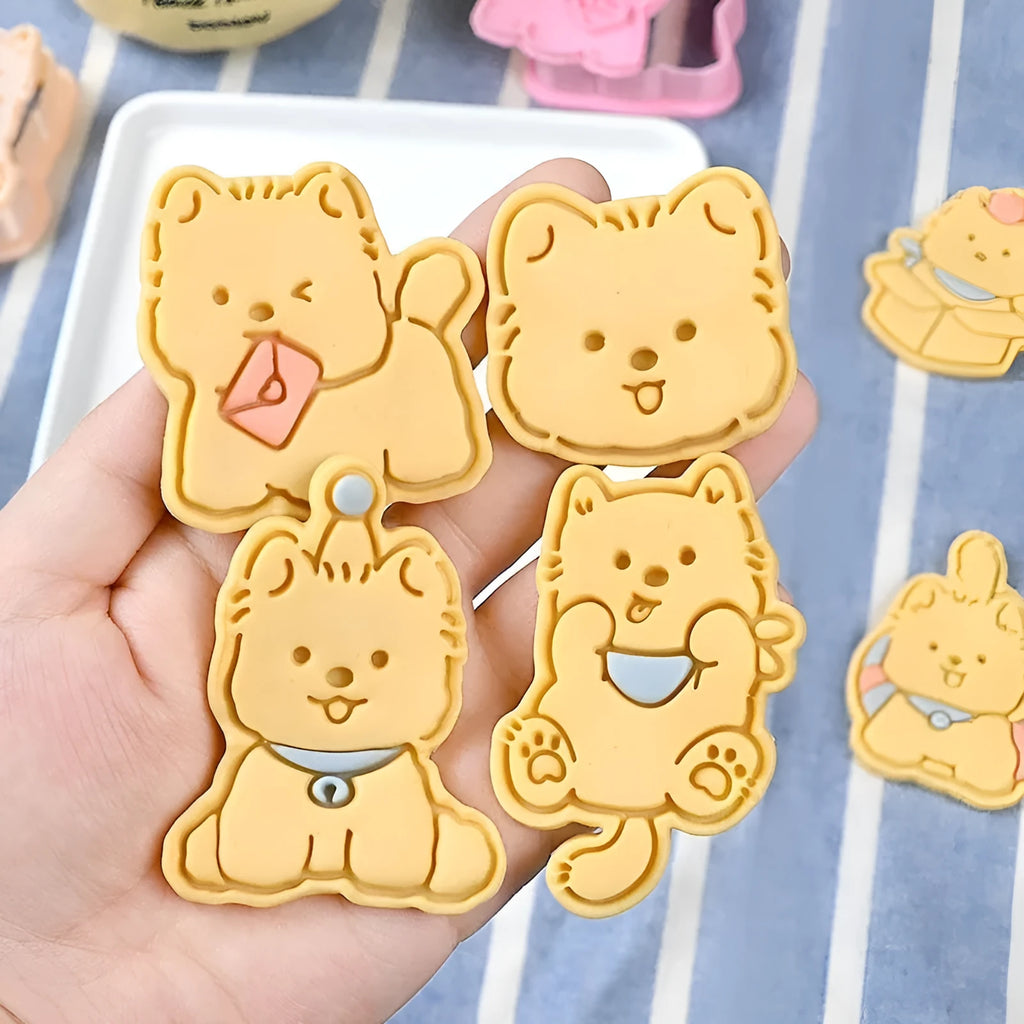 Three-dimensional plastic biscuit mold showing cartoon puppy designs including birthday hat and swimming ring motifs