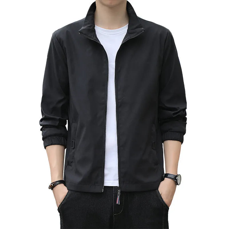 Man wearing a loose-fit black lapel jacket, Korean-style casual autumn coat with zipper pockets.