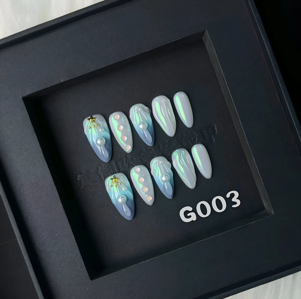 Blue plastic nail stickers and wearable nail armour pieces set on a white background.
