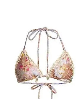Creamy-white women's floral print bikini set with matching skirt on a hanger.