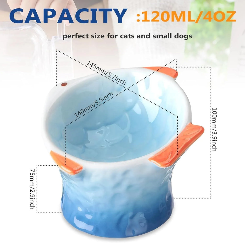 Set of four coloured fish-shaped ceramic cat bowls with a tilted, elevated design on a table.