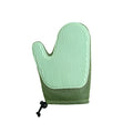 Dark blue pet hair removal grooming glove for right hand on a fabric sofa.