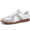 White Japanese-style retro low-top unisex sneakers with round toe and flat rubber sole on a plain background.