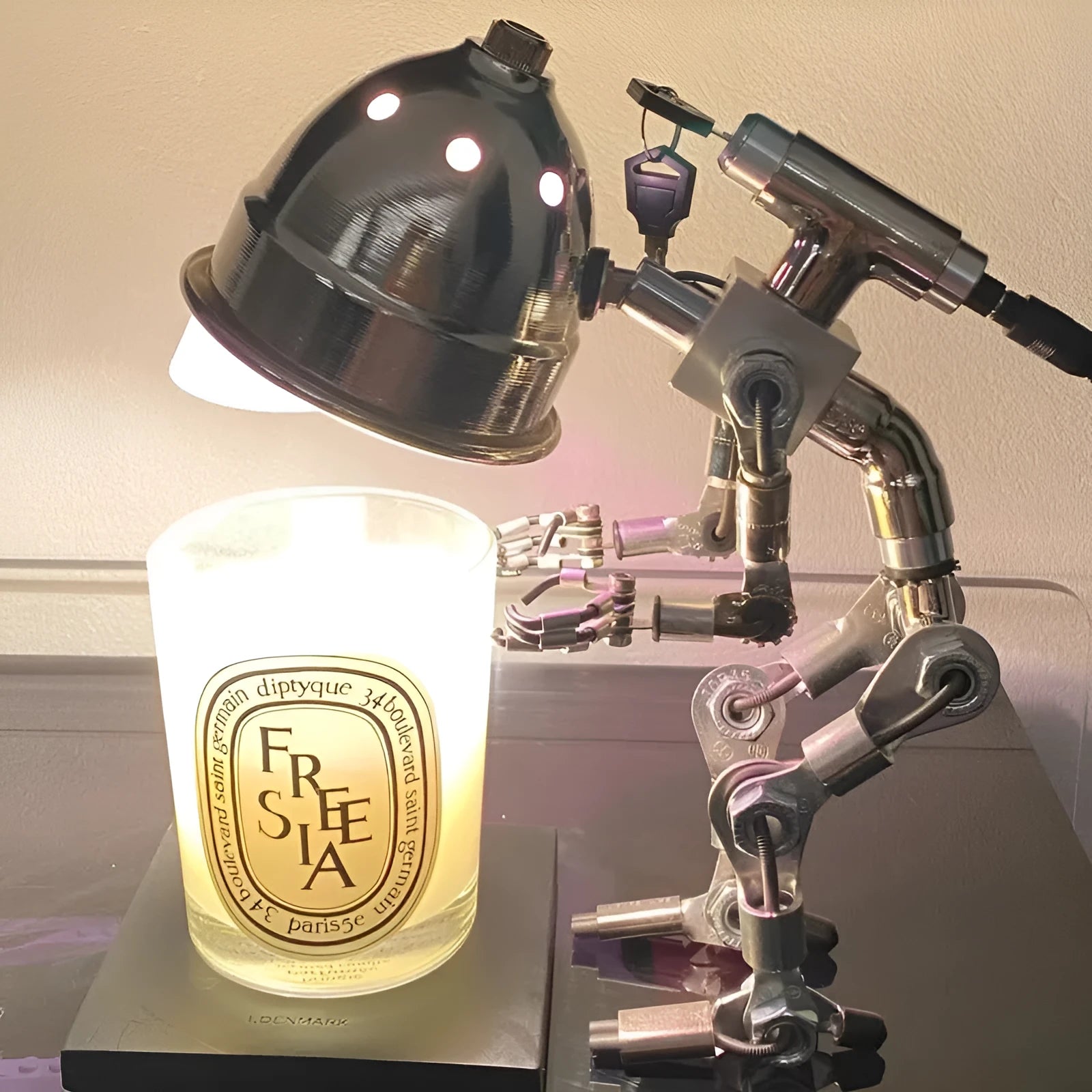 Silver and copper robot-shaped decorative desk lamp in 22cm and 29cm sizes.