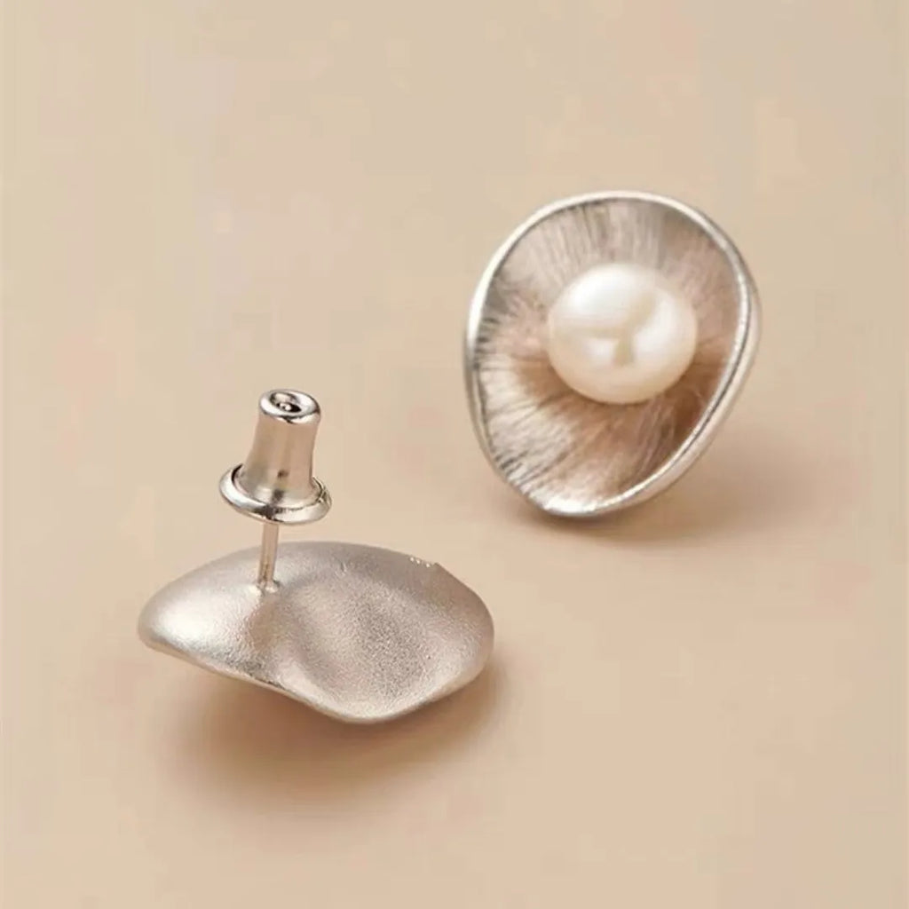 Pearl sterling silver needle earrings with geometric design elements in gold colour
