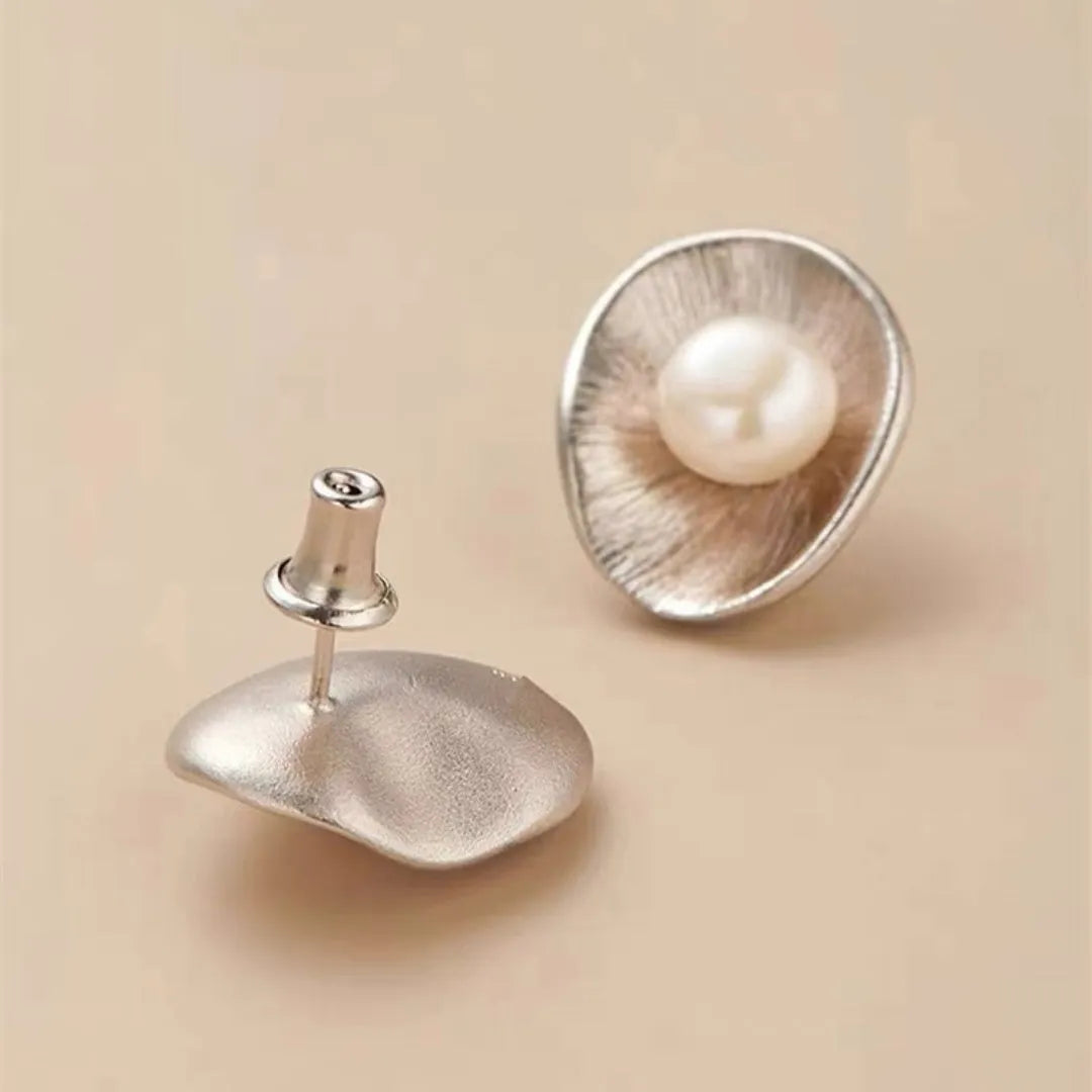 Pearl sterling silver needle earrings with geometric design elements in gold colour