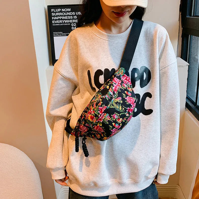 Western-style women's waist bag with large flower design and three-dimensional pockets.