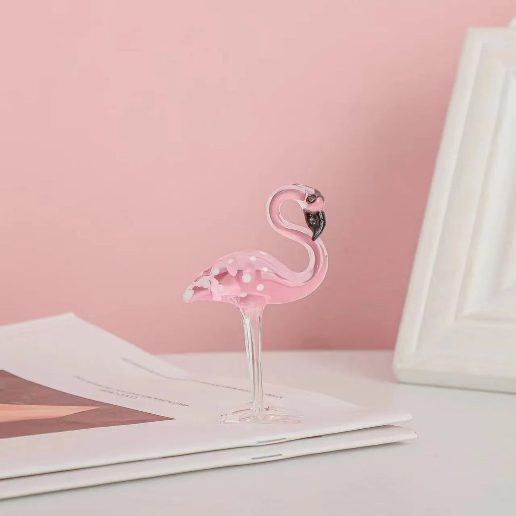White crystal flamingo decorative ornaments with pink dots on a table