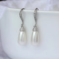 Silver alloy drop earrings with fully-inlaid artificial freshwater pearl and shell pearl surface