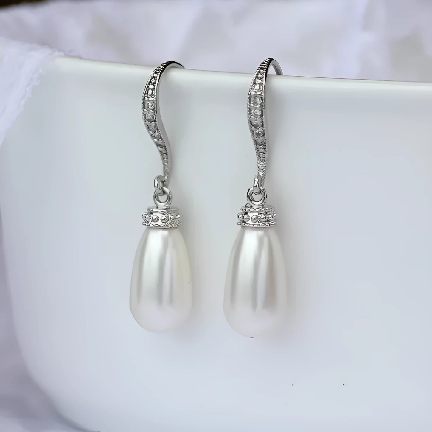 Silver alloy drop earrings with fully-inlaid artificial freshwater pearl and shell pearl surface
