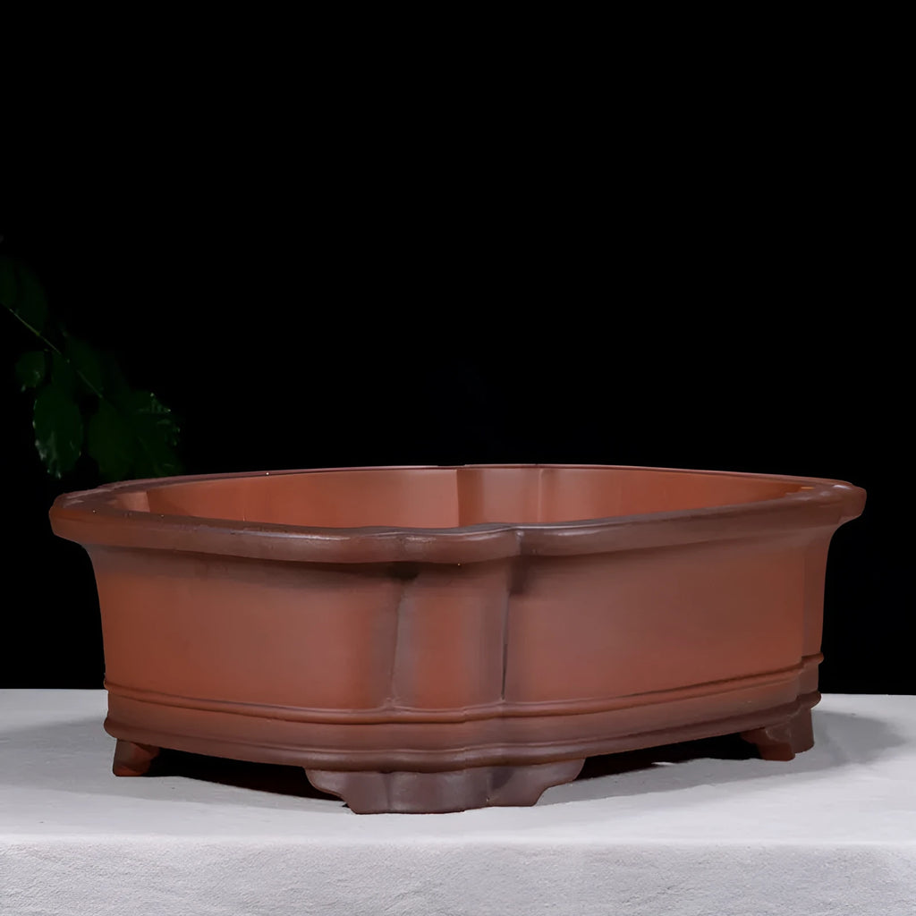 Large antique-finish Chinese purple clay flower pot with detailed tree stump and floral motif sculpture.