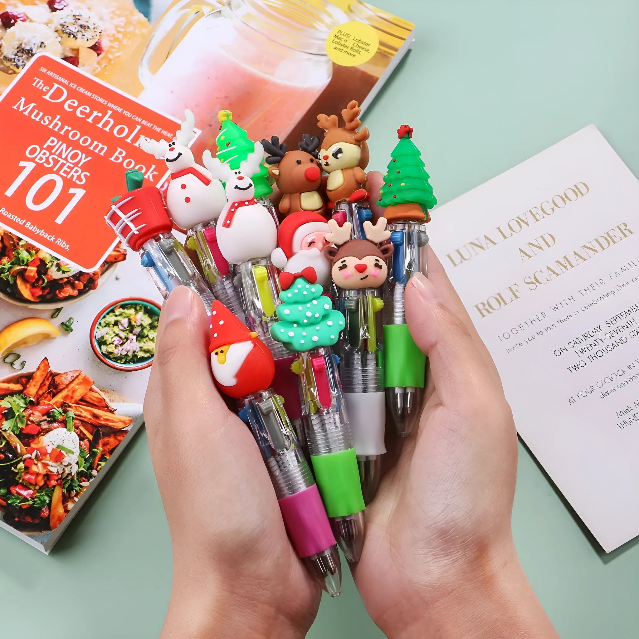 Christmas mini four-colour press-type ballpoint pen showing festive designs, 11cm long.