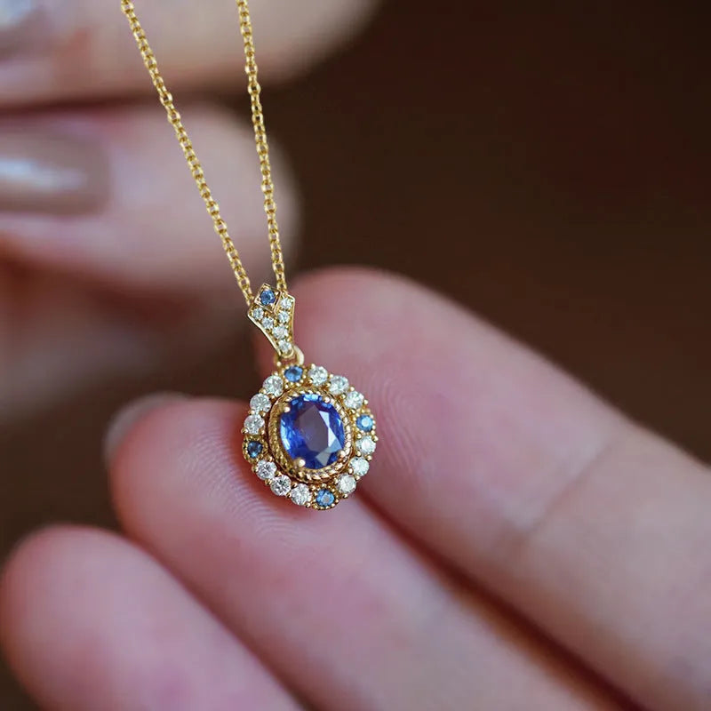Yellow gold royal necklace with mixed gem inlaid pendant on a copper box chain, adjustable length.