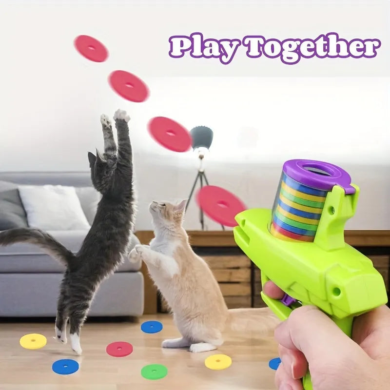 Interactive plastic cat toy launcher with foam disc projectile in green or purple colours