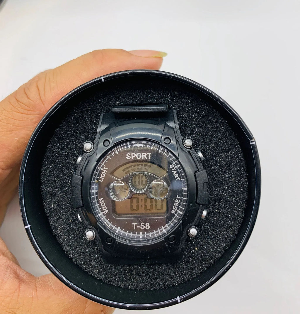 Children's digital sports watch with silicone strap and plastic case showing display with time, alarm, and calendar icons.