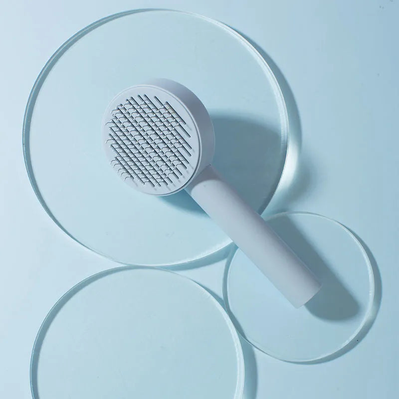 Pet cat comb hair brush for floating hair cleaner in white with one-click hair removal