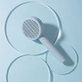Pet cat comb hair brush for floating hair cleaner in white with one-click hair removal