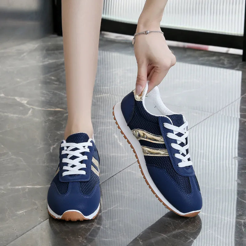 Blue women's casual tennis shoes with cross shoulder straps and a flat rubber sole