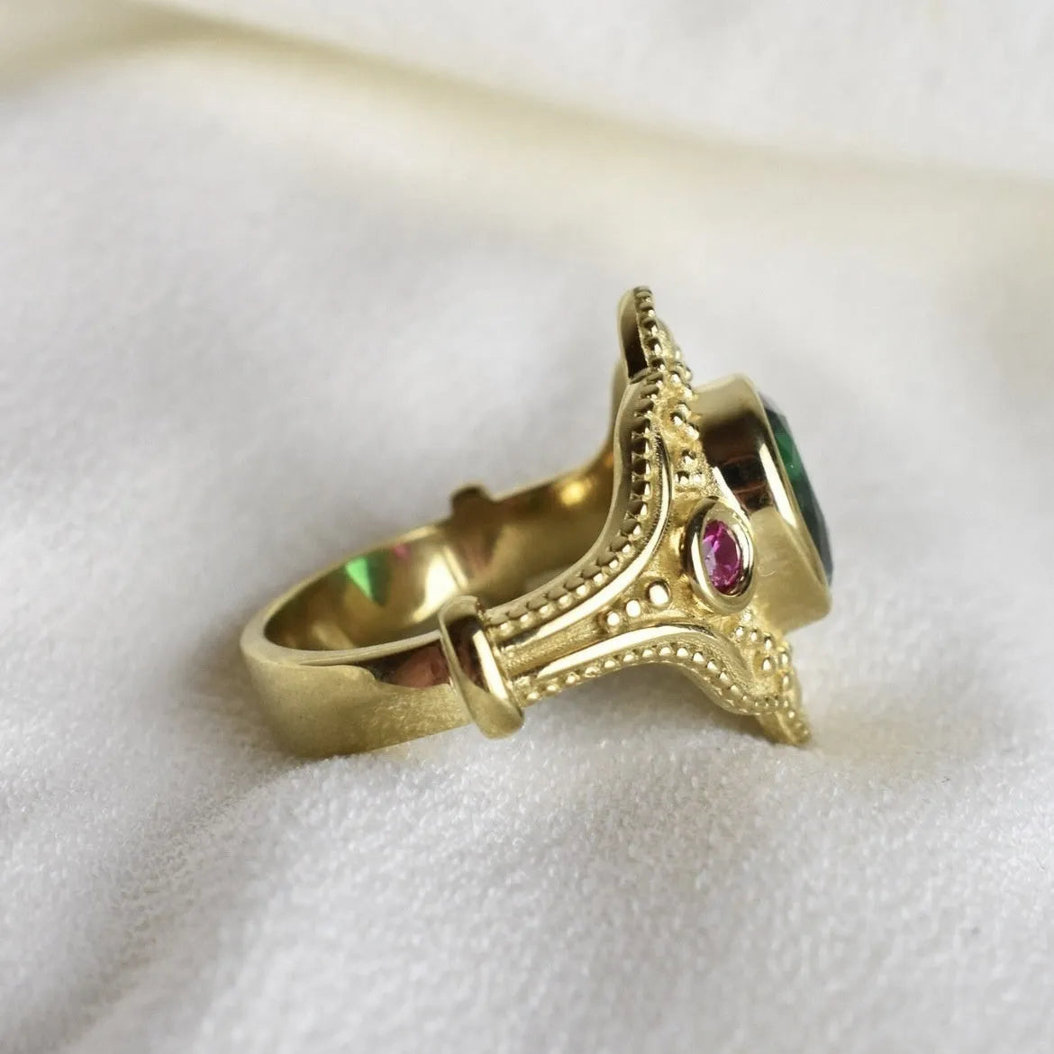 Women's geometric fashion ring in golden lvzuan colour on a grey background.