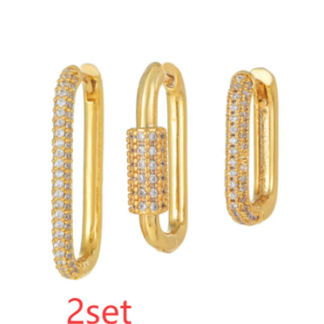 Three geometric ear clips with micro-inlaid zircon stones on copper, showing gold and white gold colour options