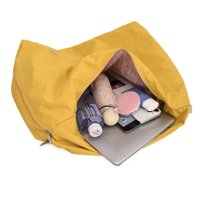 Women's heart-shaped nylon underarm bag in black, yellow, khaki, and blue colour options showing large capacity design