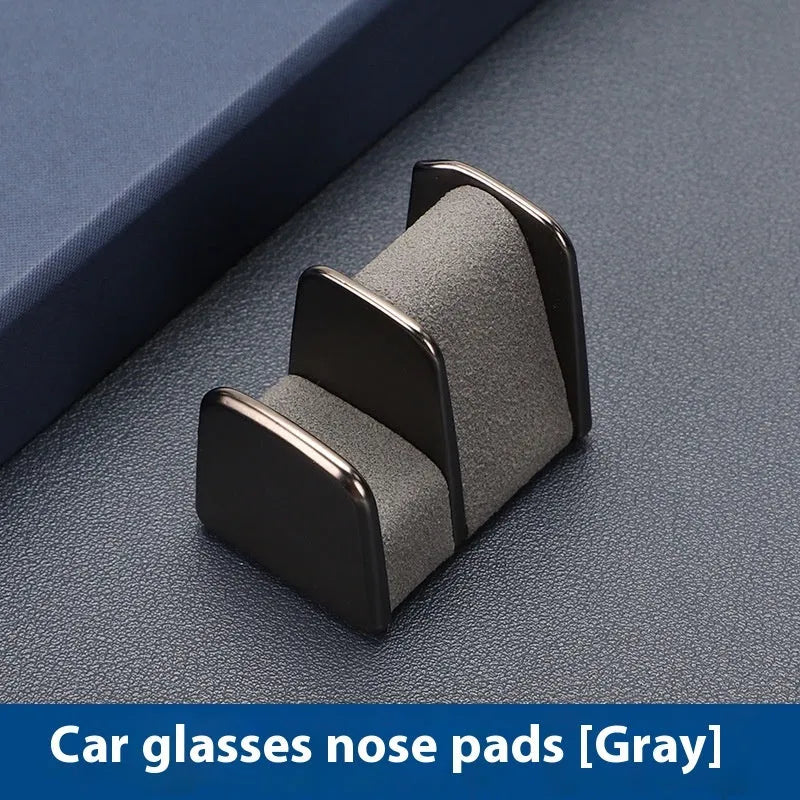 Compact zinc alloy and leather glasses clip for car dashboard, shown in available colours.