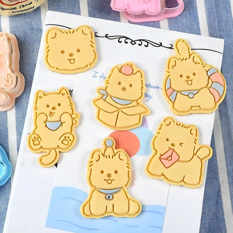 Three-dimensional plastic biscuit mold showing cartoon puppy designs including birthday hat and swimming ring motifs