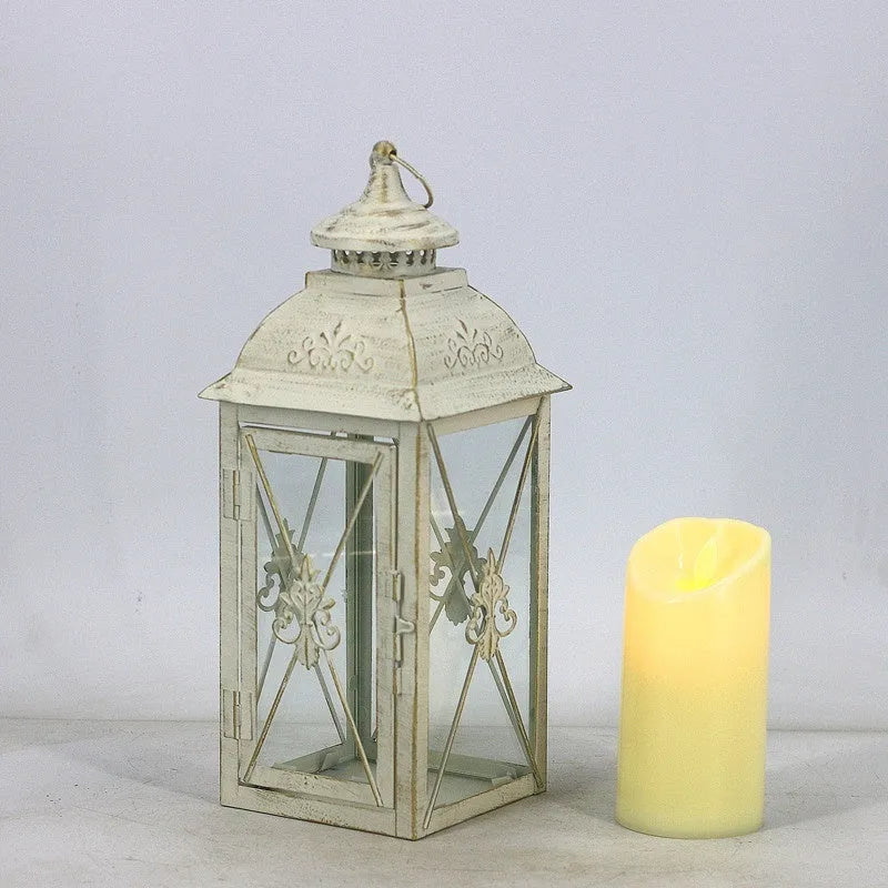 Black and white wrought iron floor-standing storm lantern with tempered glass in three sizes for courtyard use.