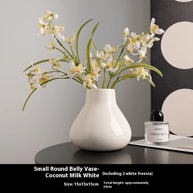 Ceramic round belly vase with coloured glaze finish in black or white, shown with artificial orchid stems