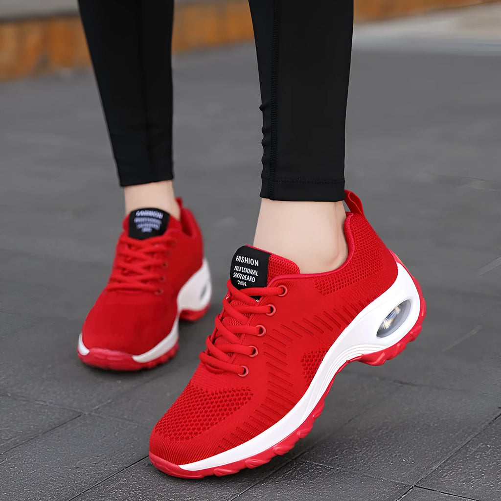 Red women's mesh sneakers with front lace-up and round toe design