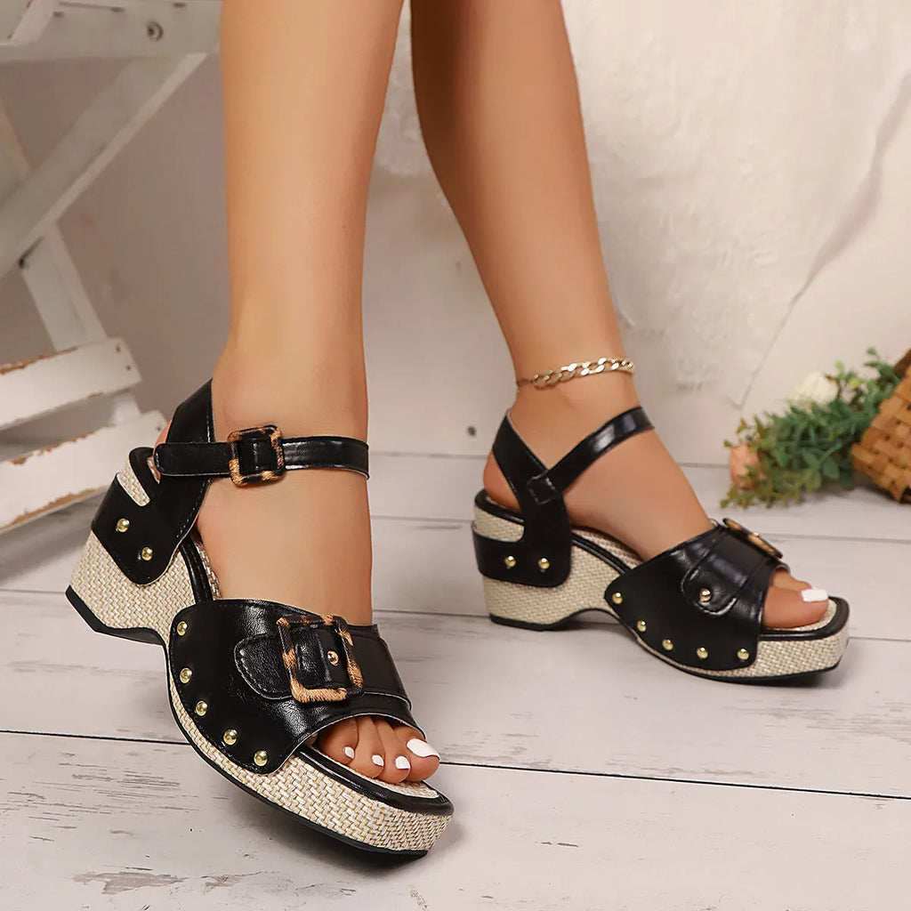 Women's white chunky heel sandals with metal buckle and square toe on a rubber platform sole.