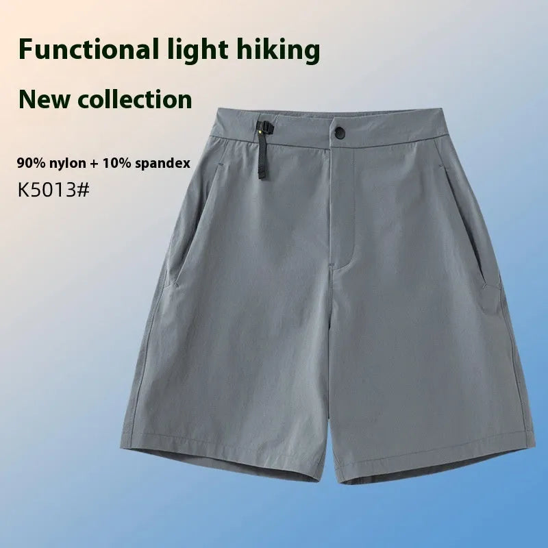 Men's solid colour quick-drying sports shorts with elastic waist on a neutral background.