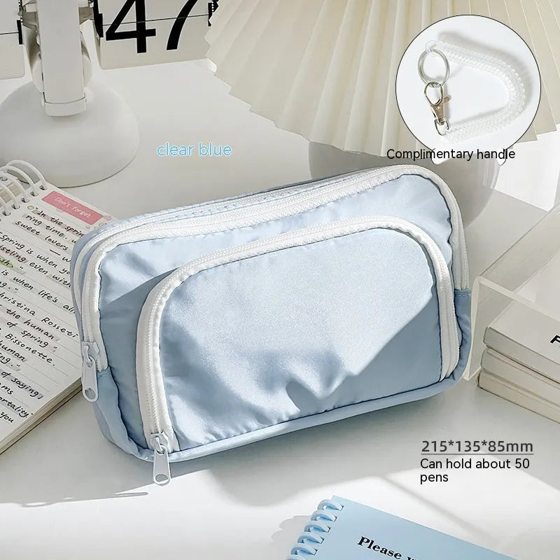 Double layer pencil case in blue, pink, green or cream with gift handle and 215x135x85mm dimensions