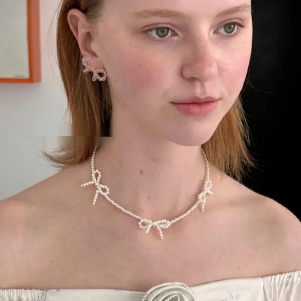 White imitation pearl necklace with geometric bow pendant on adjustable 31-40cm chain