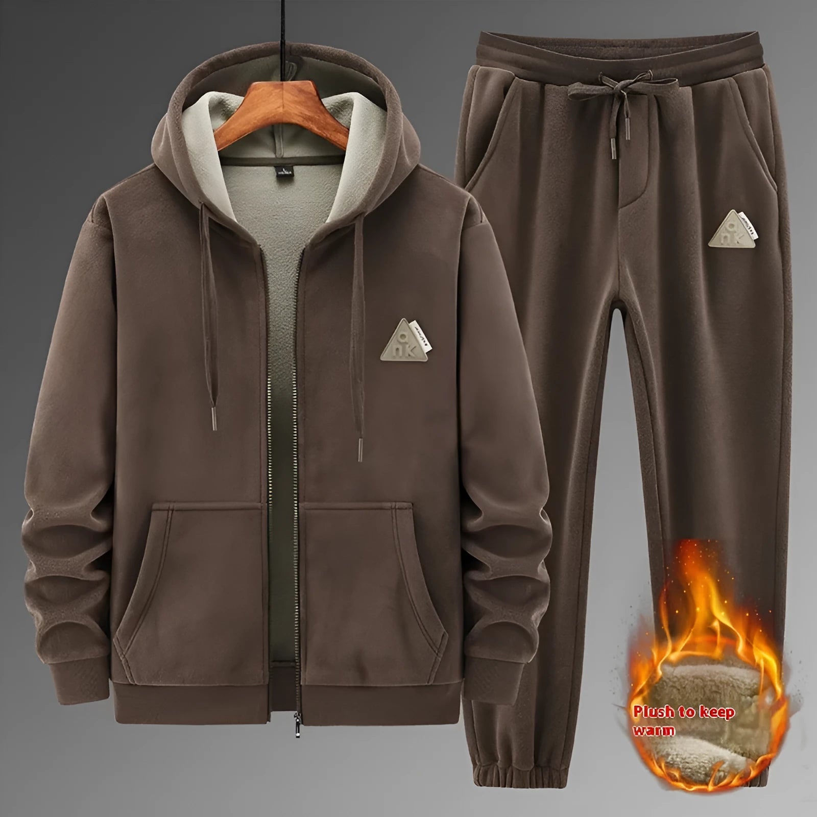 Man wearing a grey hooded cashmere sweater and matching cotton trousers from a casual sports suit.