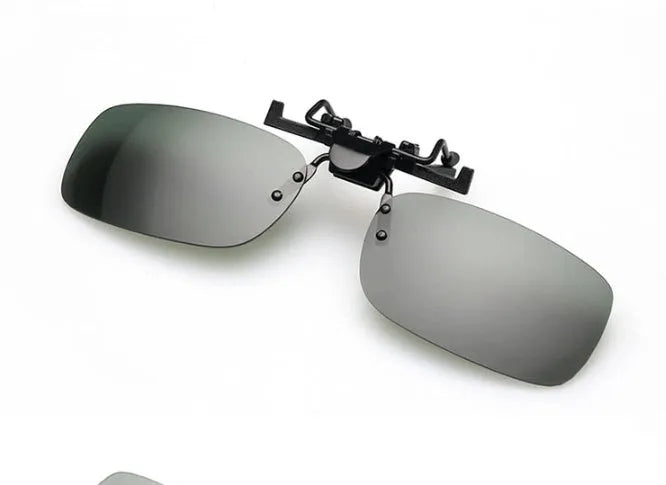 A clip-on sunglasses accessory with PC lenses shown in dark green, grey, and night vision tints, designed to fit over prescription glasses.