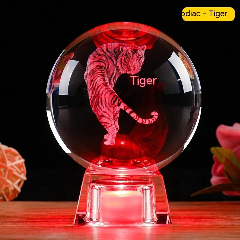 White crystal ball luminous ornament with Chinese zodiac animal design on an electronic charging base.
