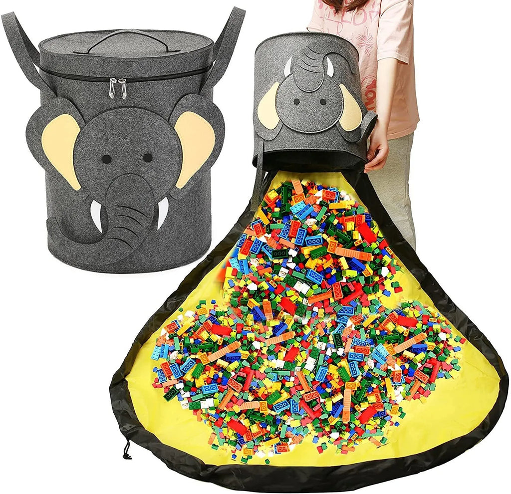 Green felt cube storage bag with pull rope open as a floor play mat for toys.