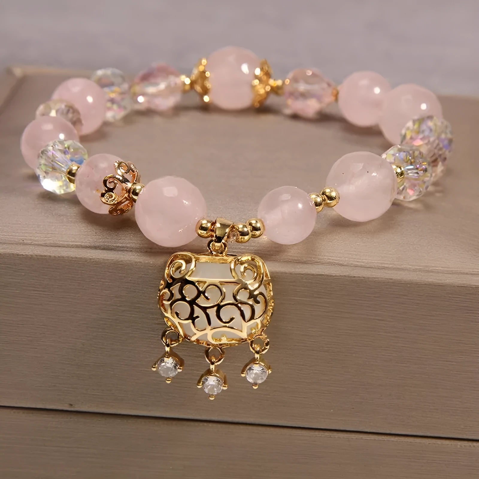 Khaki crystal bead bracelet on an adjustable gold silk cord.