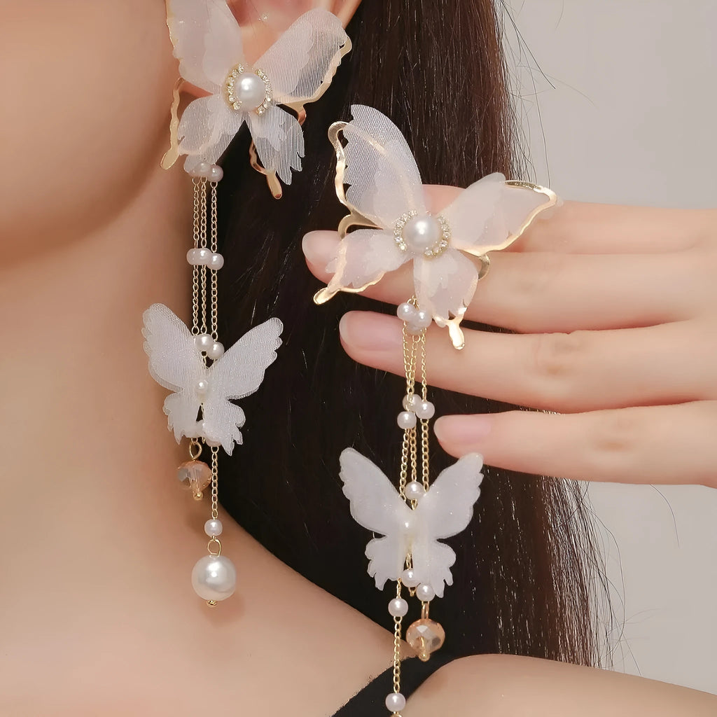 White butterfly earrings with lace details, tassels, rhinestones and pearls on copper alloy