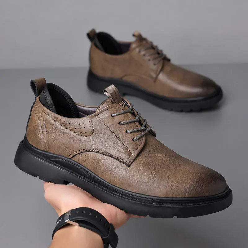 Men's black and brown leather casual sneakers with visible sewing line detail on the cowhide upper.