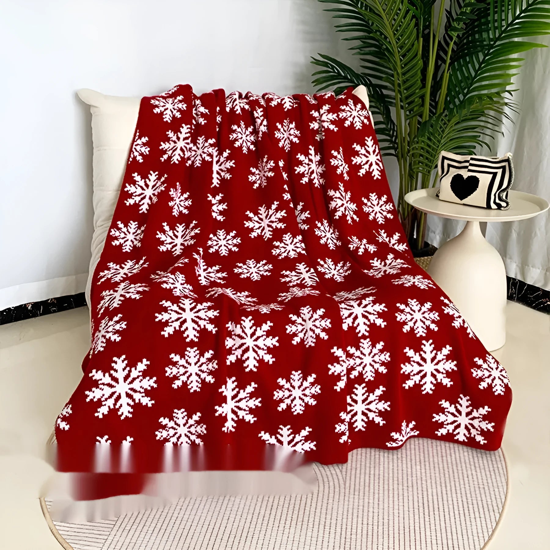 Christmas blanket with cartoon snowflake design in red and white colours