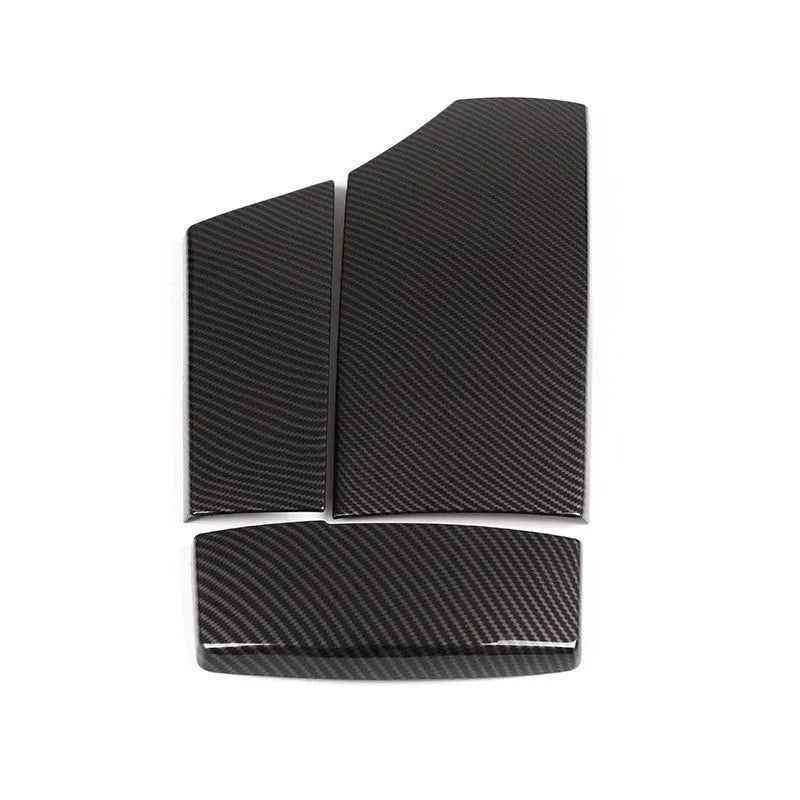 Three black ABS protective covers with a diagonal carbon fibre pattern for a car armrest box