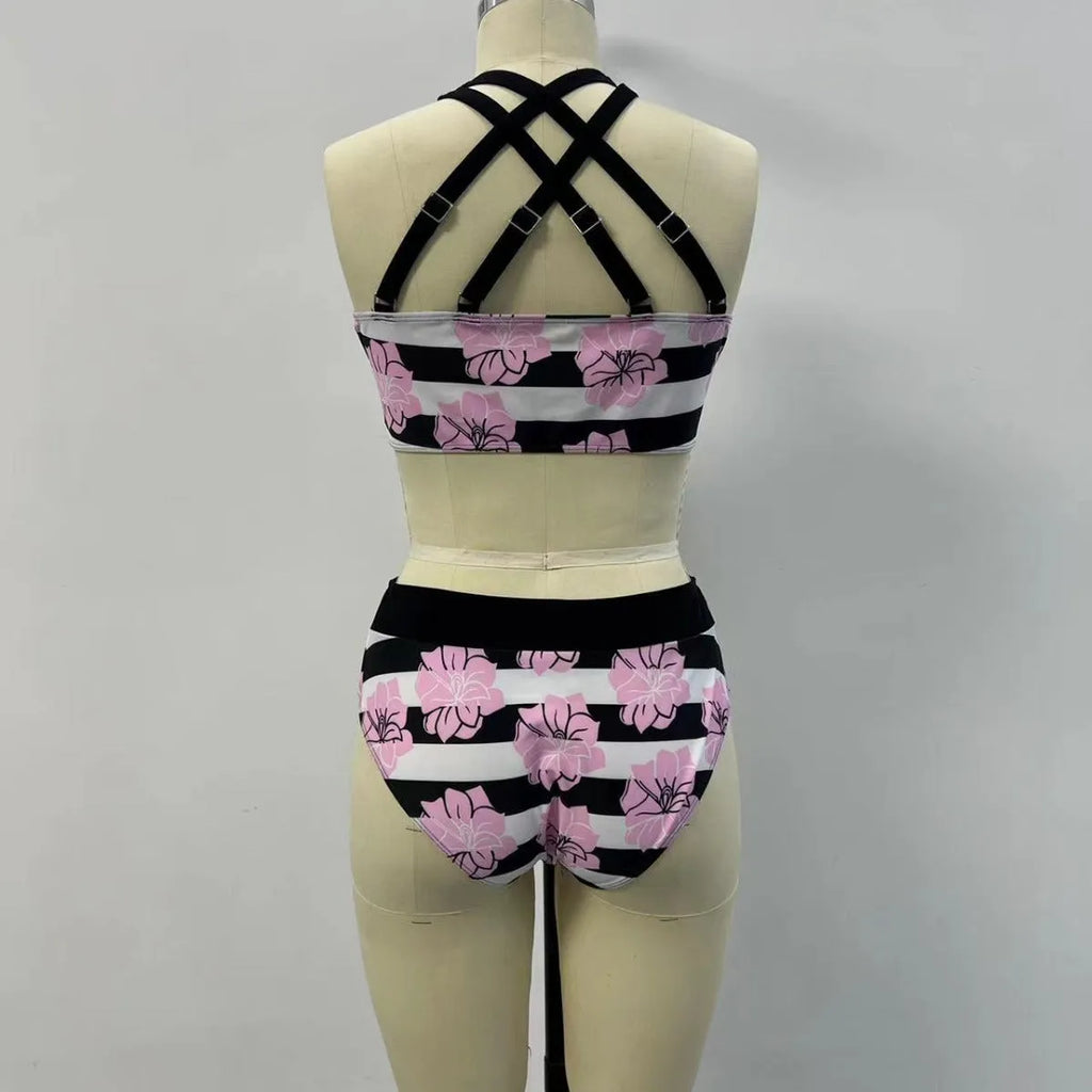 Black women's bikini with printed design, belly coverage and split leg style for swimming.