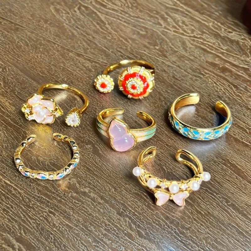 Adjustable copper women's ring with vintage oil drip finish, gourd shape, and inlaid zircon stones in floral and bow designs.