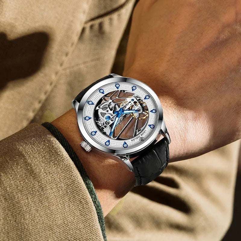 Men's silver mechanical watch with white dial, blue hands, and black genuine leather strap
