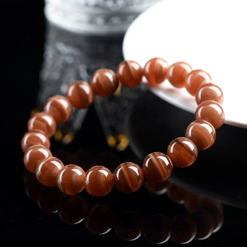 Natural Rhodochrosite round beads bracelet from Peru with geometric design and Ruyi elements
