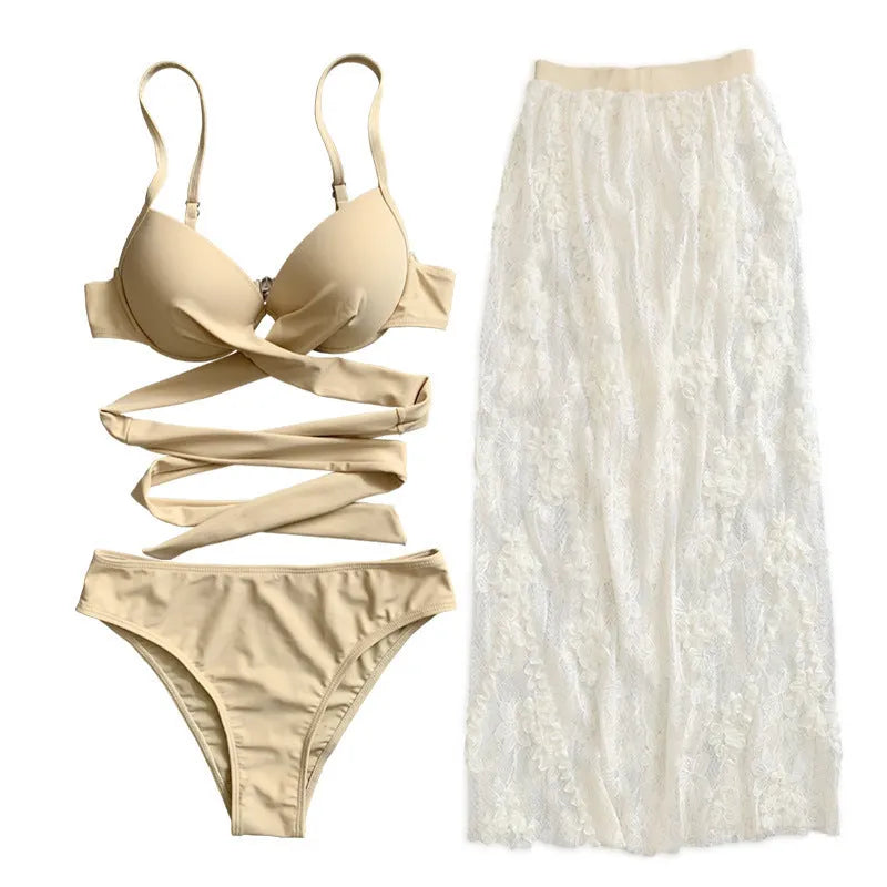 Sexy white three-piece bikini set with backless push-up top and skirt on a mannequin.