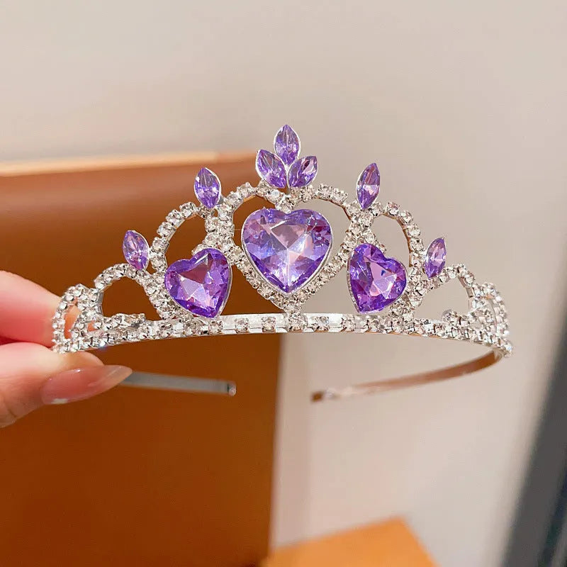 Children's electroplated alloy crown headband with pink crystals, shown on a model for scale.