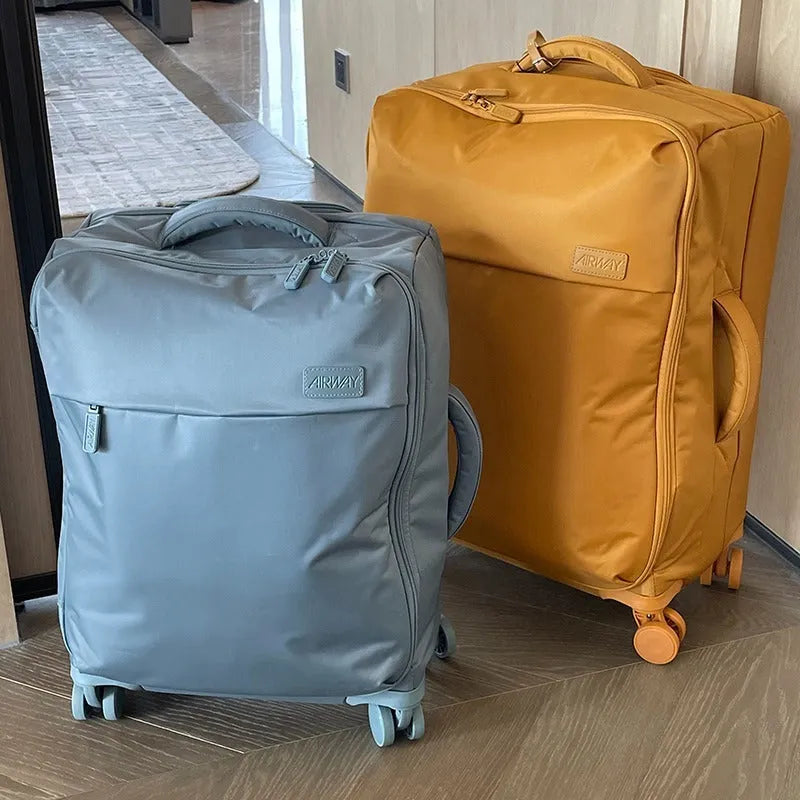 Ultra-light waterproof Oxford cloth suitcase in bluestone green with universal wheels, shown in a 24-inch size.